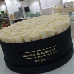 100 White Roses – Black Wrapping | Elegant Contrast Bouquet Dubai