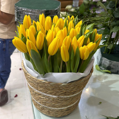 Close-up of vibrant yellow tulip blooms in a luxury gift basket, Flowerdxb Dubai delivery