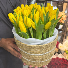 50 yellow tulips in a decorative luxury basket for birthday or Eid gift, same-day delivery Dubai Sharjah